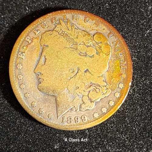 1899年Oミント モーガン銀貨、ローボール、カラー入り。「In God We Rust.」T651...