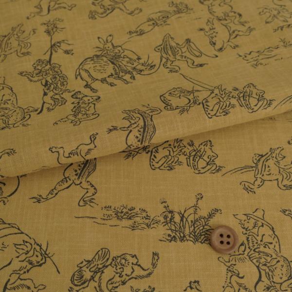 和柄コットン生地・鳥獣人物戯画(からし色) 10cm単位 切り売り