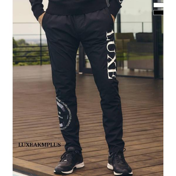 LUXEAKMPLUS リュクスエイケイエムプラス サークルロゴウィンドパンツ メンズ ジャージ シ...