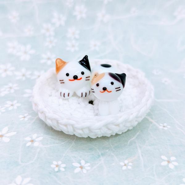 ネコベット（L)ミケ親子のガラス細工の置物です。＊ベットは綿１００％手編みです。【大きさ】約高さ１５ミリ　　直径４０ミリ　（ベットの大きさ）＊商品は一つ一つ手造りのため大きさや色合いなどが写真と異なる場合がありますのでご了承をお願い致します。