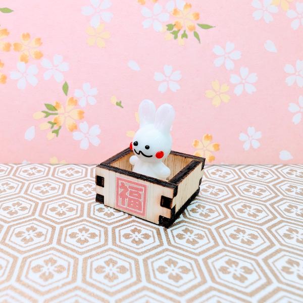 福桝卯のガラス細工の置物です。桝は木製です。【大きさ】約高さ２５ミリ　　横幅２０ミリ　　　　　奥行２０ミリ＊商品は一つ一つ手造りのため大きさや色合いが写真と異なる場合がありますのでご了承をお願い致します。