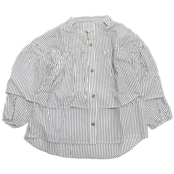 Ocean＆Ground オーシャン＆グラウンド“オーシャン＆グラウンド”の8分袖ラッフルシャツチュニック軽やかなコットンストライプ素材の八分袖シャツ。ギャザーをたっぷりよせ、存在感のあるラッフルデザイン。落ち着いたストライプ柄で着回しやす...