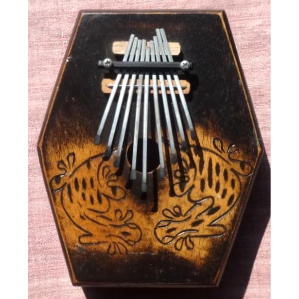 六角形の形をした箱形のバリ・カリンバです。太めの弦の響きが箱の中で共鳴して、深く心地よい音が鳴り響きます。弦の留め具はネジ式になっており、+ドライバーで緩めることで弦の長さを調節でき、チューニングできます。サイズ−タテ/ヨコ:約19×16c...