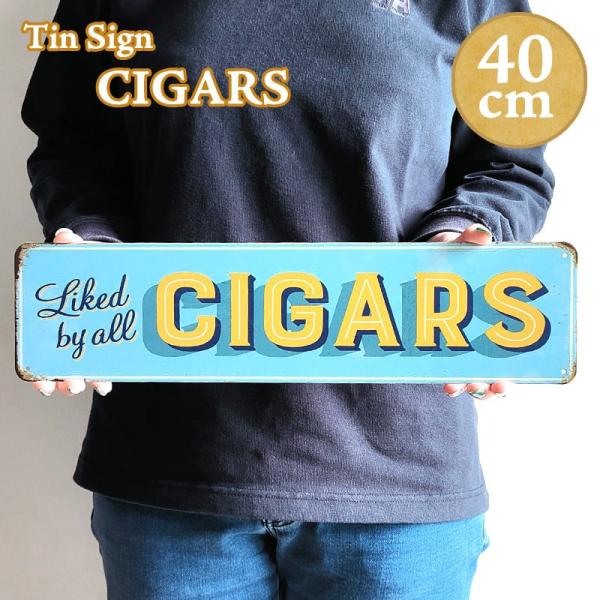 「横長ティンサイン CIGARS」ライトブルーとイエローのロゴの組み合わせがおしゃれな横長ティンサインです！四隅に壁掛け用の穴が開いておりコンパクトなサイズなので、お部屋やガレージ等に気軽に飾ることができます。-アメリカンブリキ看板とは-か...