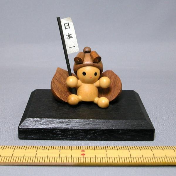 木製の小さなお人形の置物です。黒台と人形は接着されています。サイズ：黒台間口6.5cm、黒台奥行4.8cm、全高4.5cm