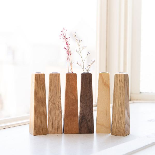 天然無垢材で作られた卓上の一輪挿し。さりげなく飾れる四角錐が登場いたしました。ガラス瓶付きのお洒落なデザインで、お部屋のインテリアに自然に馴染む小さめサイズの飾りやすいフラワーベース。■ ブランド：沖家具(OKIKAGU)■ カラー：くるみ...