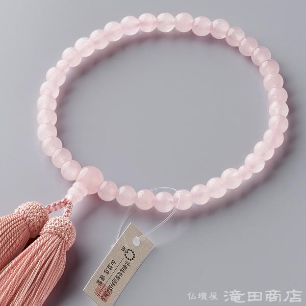 珠の素材：紅水晶(ローズクォーツ) 7mm玉房の素材：正絹頭付房（桃花色）備考：数珠袋付き、数珠は紙箱入りすべての宗派でお使いいただける女性用の念珠です。紅水晶の7mm玉を使用しました。正絹の頭付房がついています。数珠袋（数珠入れ）をお付け...