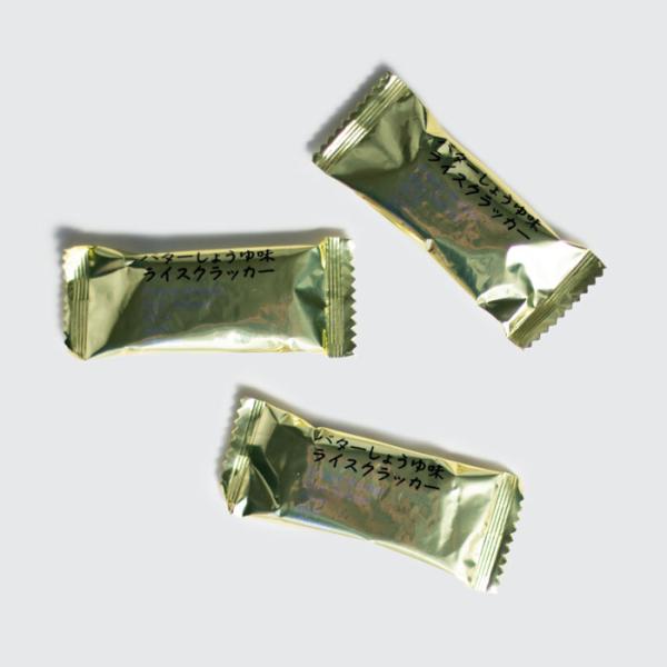 サクサクと軽い米菓子に、醤油と香り豊かなバター風味の味付けをしております。当店は広島県にて豆菓子、ナッツ、お菓子、おかき、あられ、珍味、チョコレート、個包装されたおつまみなどを販売しておりますチャーム（おつまみ）の専門店で主に一口サイズの商...