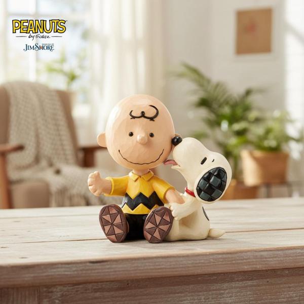 チャーリー・ブラウンとスヌーピーが並んで座る、ジム・ショアが描く心温まる情景です。スヌーピーが愛情たっぷりに頬を舐め、それを受けて穏やかに微笑むチャーリーの姿からは二人の深い絆が感じられます。ジム・ショア独特のパッチワーク模様がどこか懐かし...