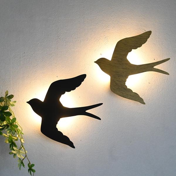ツバメモチーフのウォールデコレーションです。そのまま飾っておくだけでも十分おしゃれですがLEDライト付きなので点灯させれることもできます。昼間は消灯、夜間は点灯することにより２つの表情を楽しむことができます。ボタン電池式なのでお好きな場所に...