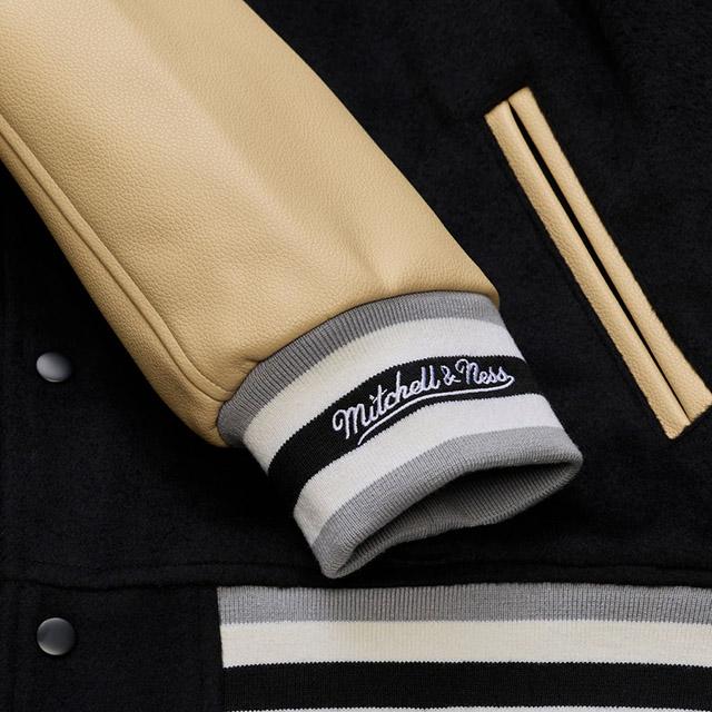 海外取寄 ミッチェル&ネス スタジアムジャケット ラスベガス レイダース NFL TEAM TRADITIONS VARSITY FULL-SNAP JACKET BLACK-TANの画像