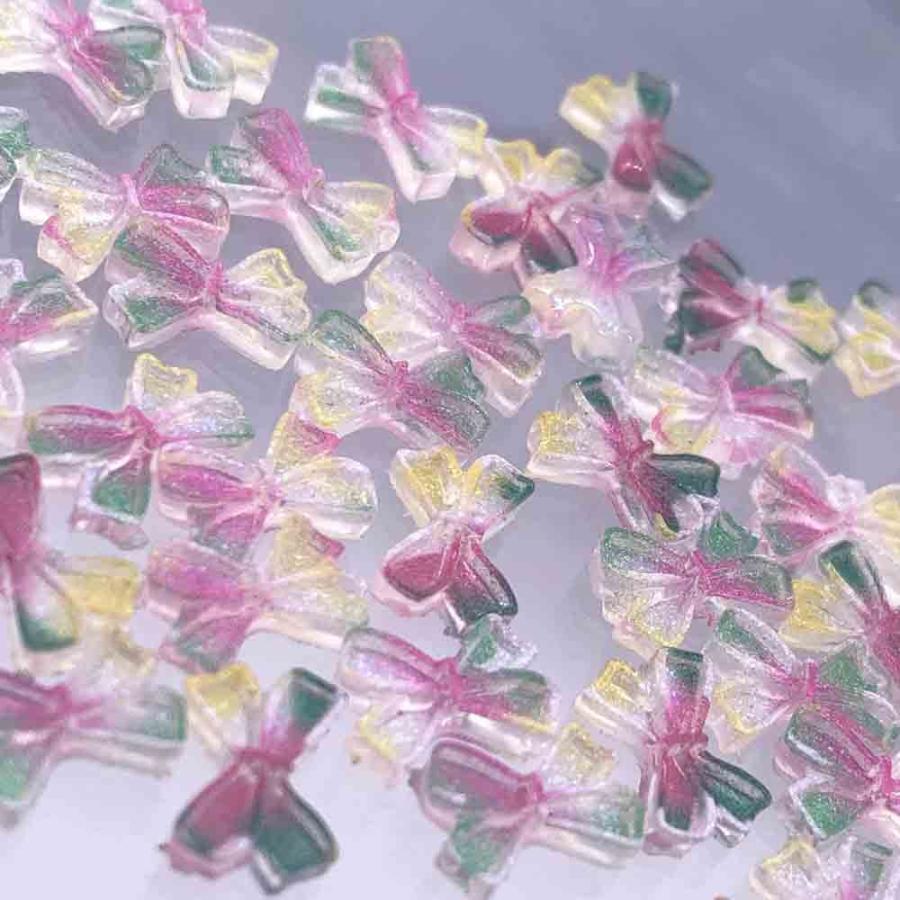 ネイルパーツ リボン 小さめ 10mm 混色 50個 虹色 ラメ 3D 蝶々結び