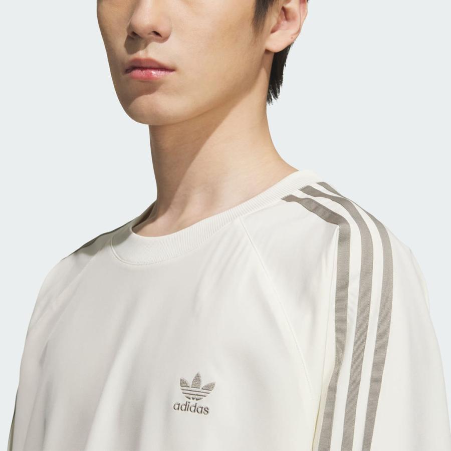 adidas（アディダス） adidas WOVEN PULL OVER TOP IVORY/SILPEB