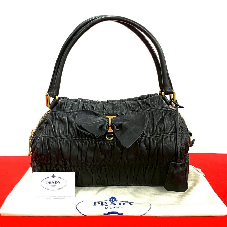 PRADA（プラダ） 極 美品 袋 鍵付き ロゴ 金具 リボン モチーフ レザー 