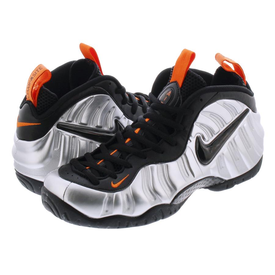 silver black and orange foamposites