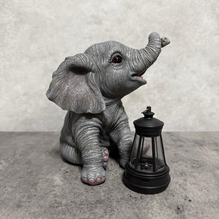 象の置物 ソーラーランプを鼻で持ち上げる赤ちゃんゾウ 高さ15.3cm