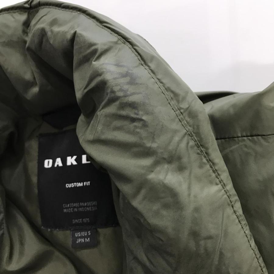 OAKLEY（オークリー） 中綿ジャケット カーキ×グレー ロゴ黒 フード
