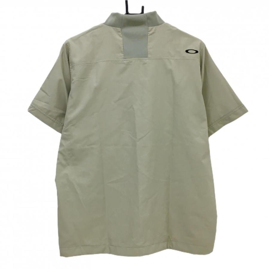 【超美品】オークリー 半袖ハイネックブルゾン ベージュ ロゴ黒 撥水 防風性 ストレッチ  メンズ M ゴルフウェア 2024年モデル Oakley OAKLEY（オークリー） 【超美品】オークリー 半袖ハイネックブルゾン