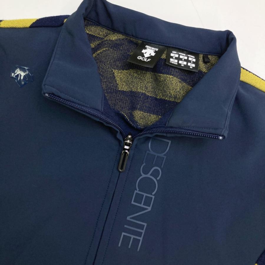 サイズ：M DESCENTE GOLF デサントゴルフ  切替 ジップジャケット 総柄 ネイビー系 [240101434582] ゴルフウェア メンズ ストスト DESCENTE GOLF デサントゴルフ 切替 ジップジャケット 総柄