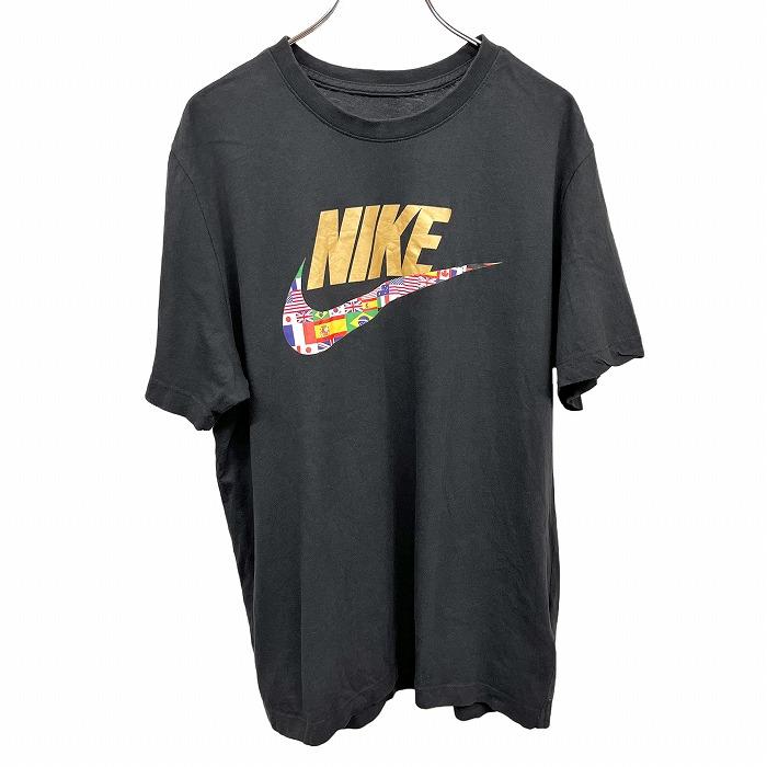 ナイキ ブラック スニーカー スウッシュ ロゴ BK ルーズ Tシャツ 新品M NIKE Tシャツ 国旗とスウォッシュのプリント 英字 文字 半袖 綿