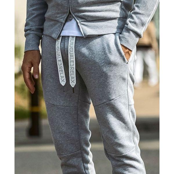 1PIU1UGUALE3 RELAX パイピングロゴワイドスピンドルジョガーパンツ