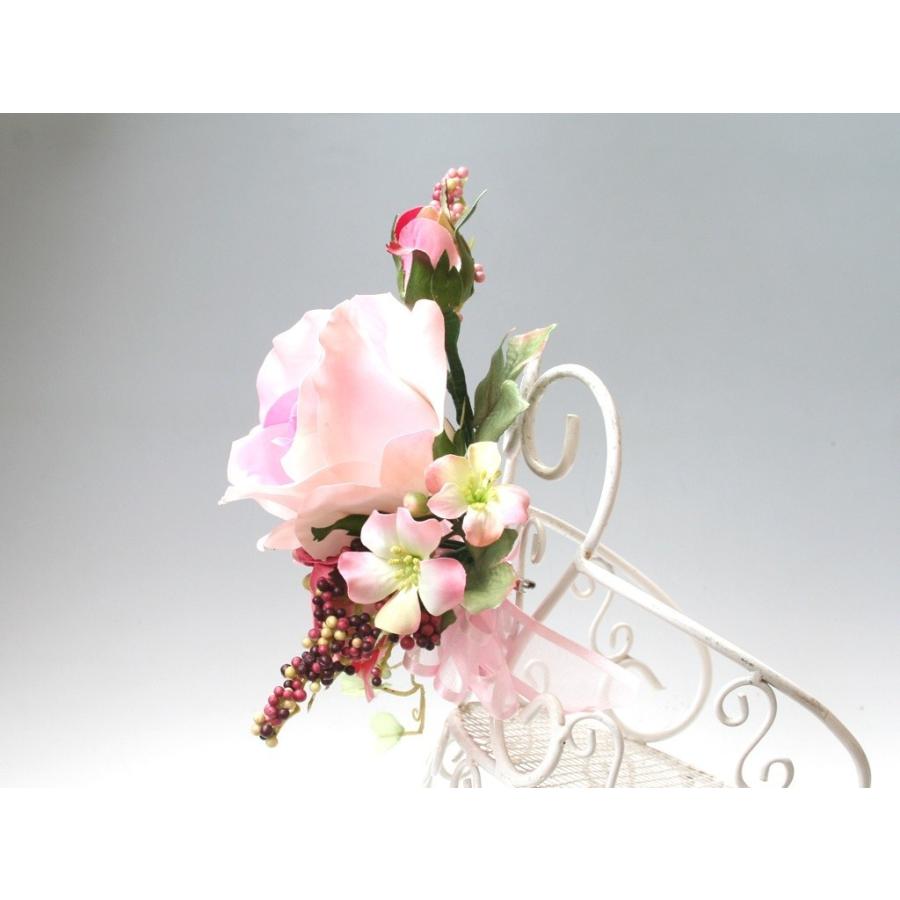 ピンクの流れるようなラインのバラのコサージュ |  | 04